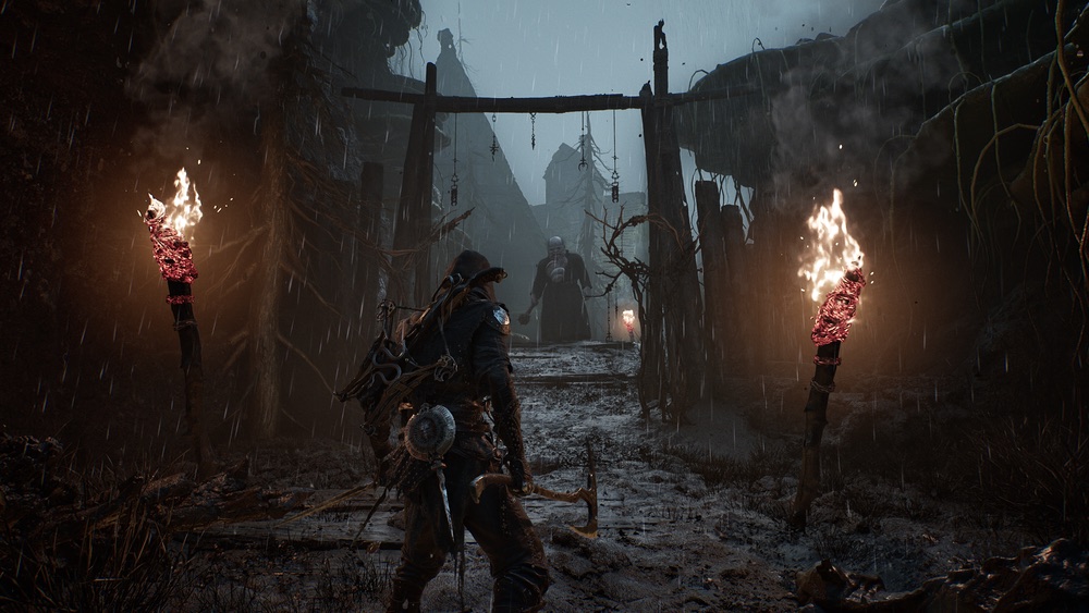 Official Mortal Shell II screenshot showing a dark settlement route and nearby enemies.